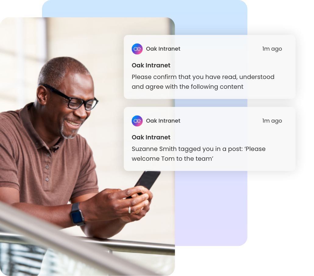 Man smiling at phone with Oak Intranet must-read document notifications displayed.