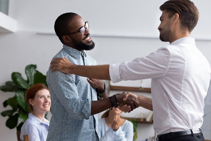 An image of two people in the workplace shaking hands